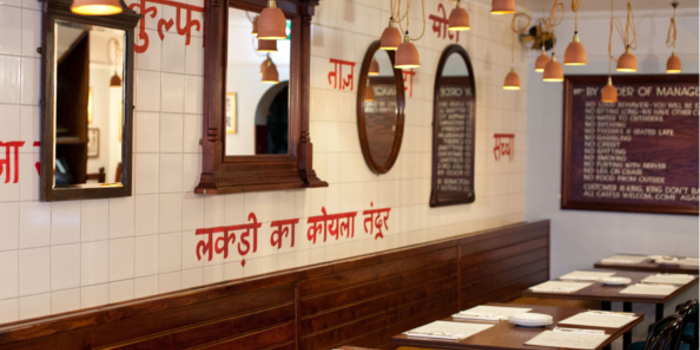 The interior of a restaurant with Indian decor.