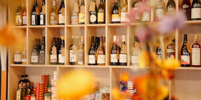 Wooden shelving filled with bottles of wine and spirits.