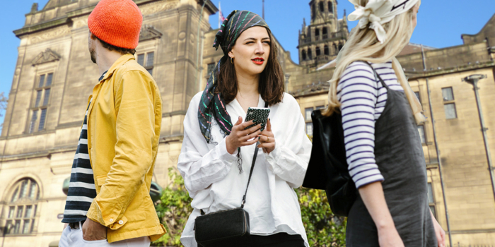 Three people having fun on a treasure hunt in Sheffield.