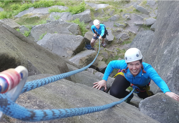 A person learning to rock climb.