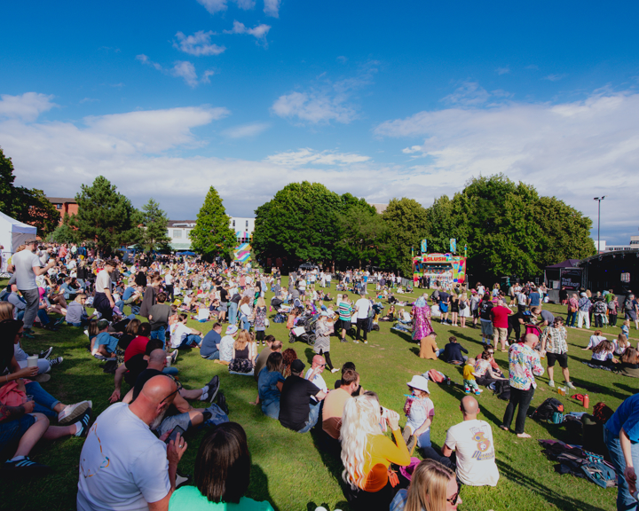 Blue skies over Devonshire Green as groups of people sit in the sunshine watching performances on the Fringe main stage 