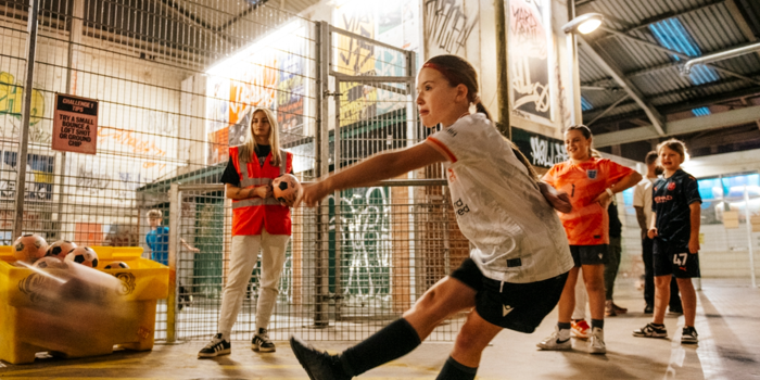 Children playing football at Yard Ball, an indoor football park.