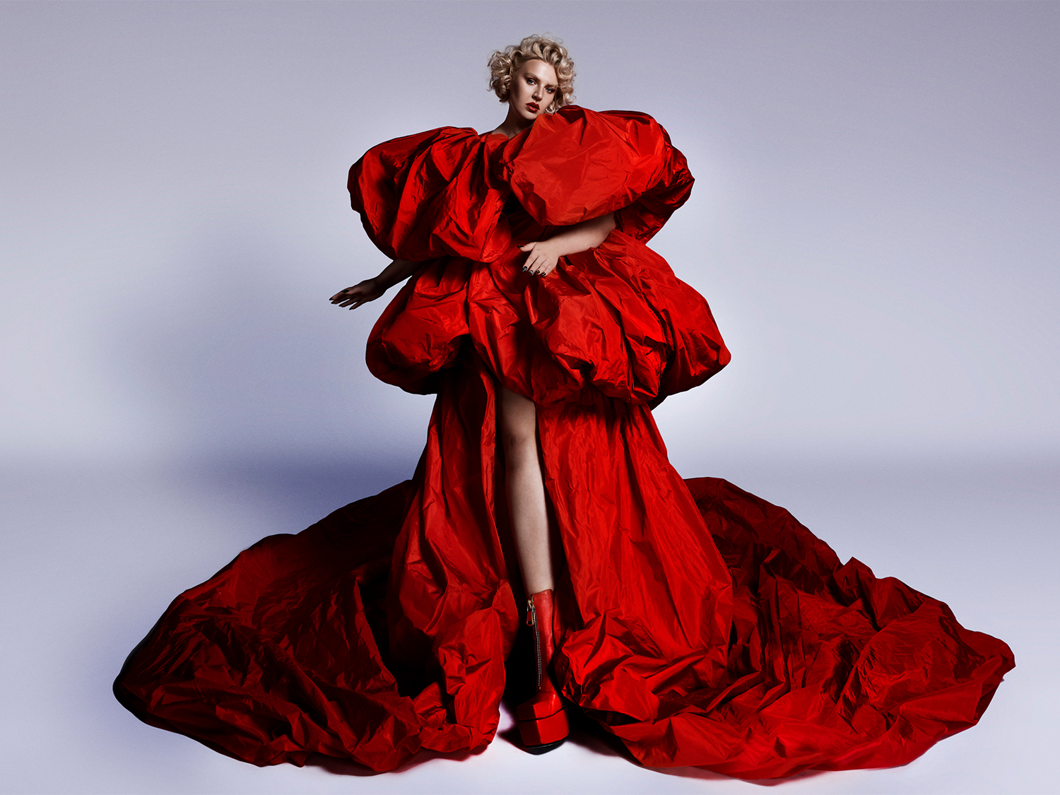 The artists Self Esteem in a huge red ballgown.