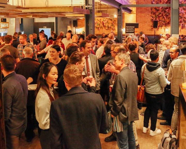 Entrepreneurs mingle at a busy networking event. 