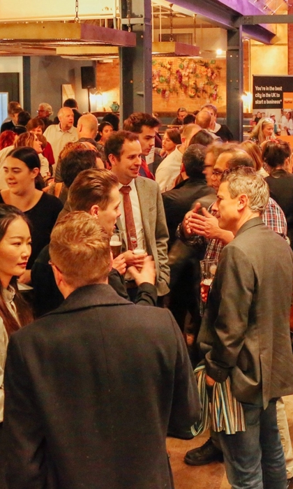 Entrepreneurs mingle at a busy networking event. 