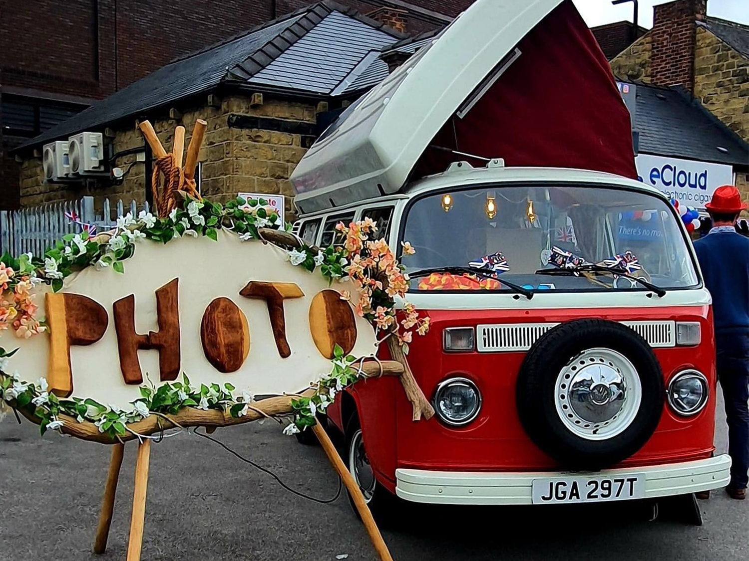 A vintage VW Camper Van set up for people to have their photos taken it.