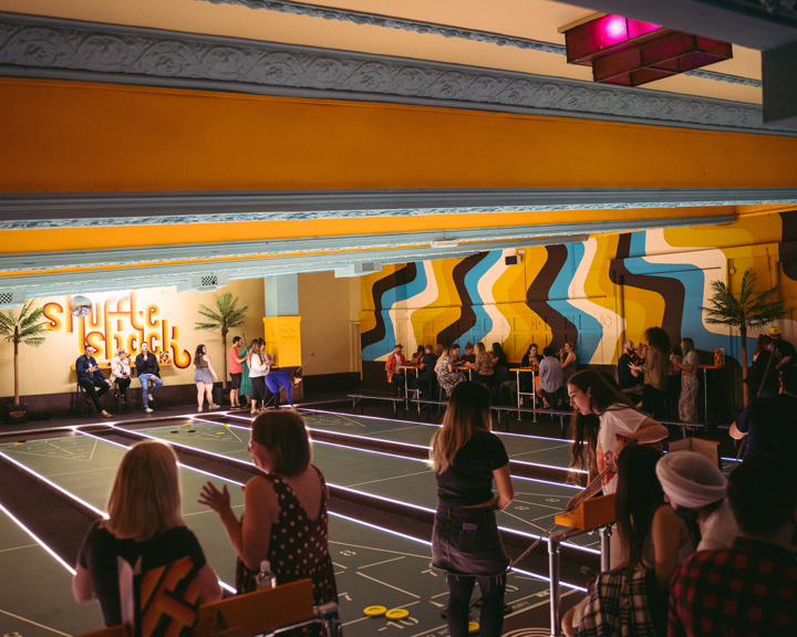 People at playing shuffleboard at Shuffle Shack at Picture House Social.