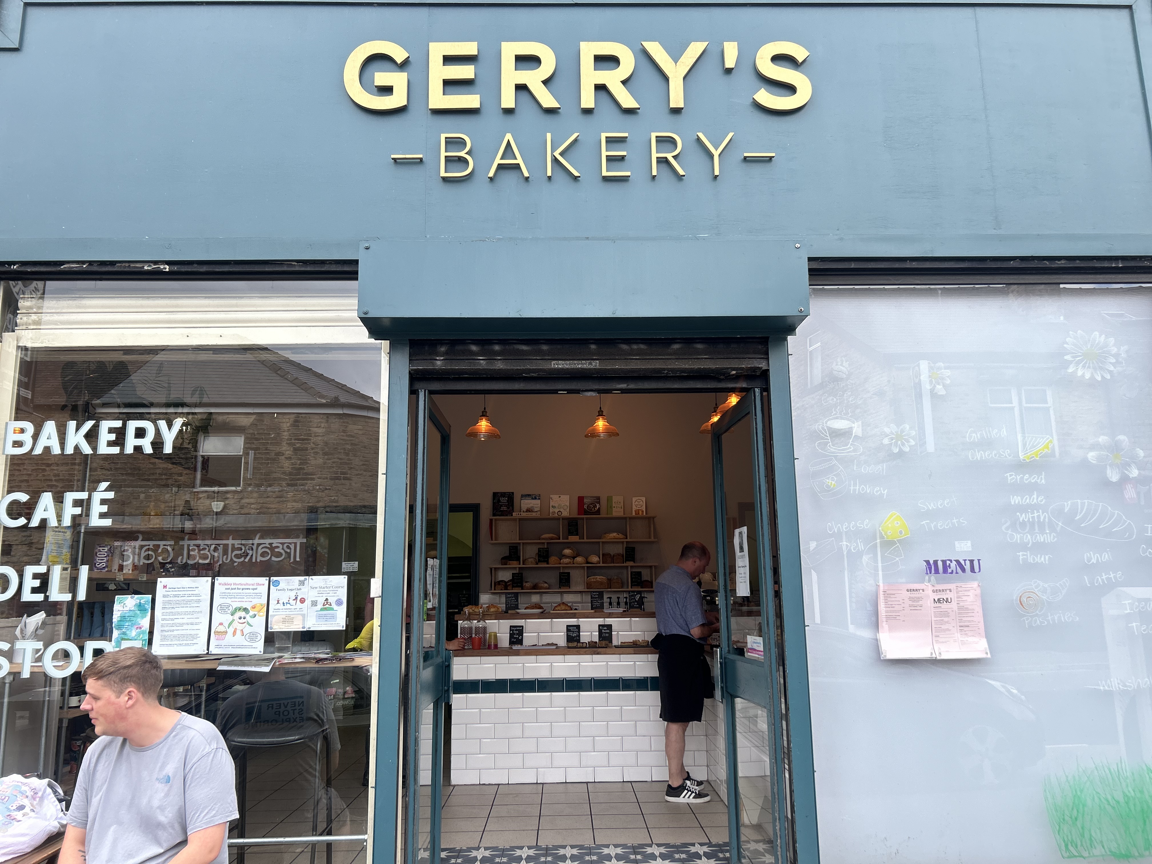 A photo of outside the the bakery, with the sign on top that reads Gerry's Bakery in gold letters