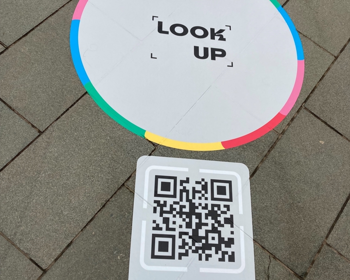 A close up of the  Look Up Portal Sticker that has been placed on paving slabs.