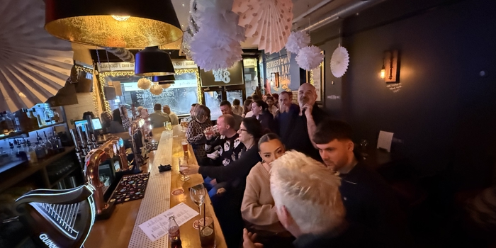 The interior of a lively and packed bar.