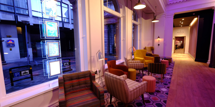 A waiting area at Curzon Sheffield, with armchairs and coffee tables.