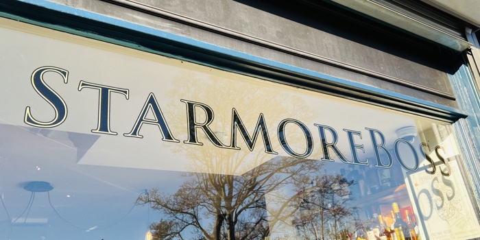 A windoe with Starmore Boss painted on it in gilded lettering.