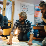 People gathered round looking at a map.
